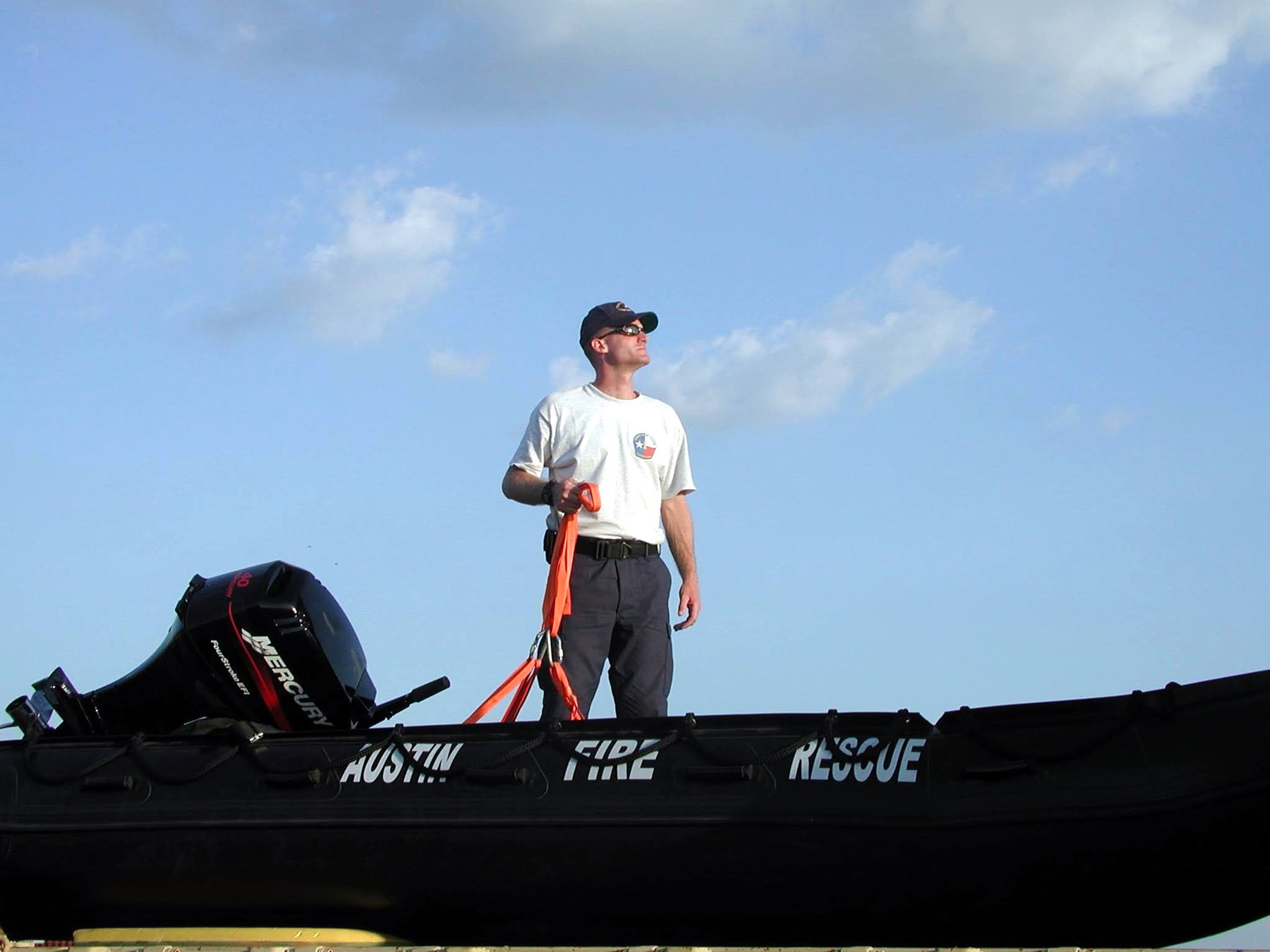 Travis Maher standing aboard an Austin Fire Rescue boat